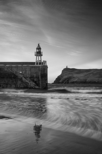 Port Erin Breakwater and Milner's Tower. The Breakwater light reflecting on the sand.
