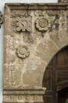 San Jerónimo, façade, main portal, left spandrel rosettes