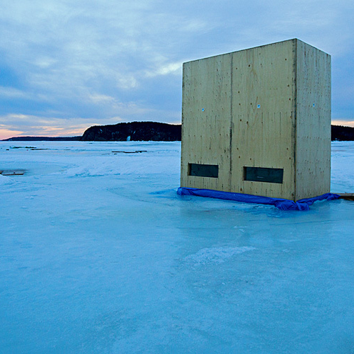 An ice shack in the form of a large double door refrigerator.