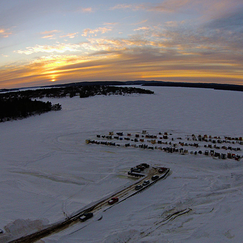 The sun sets on another day of ice fishing at the Renforth Village in Rothesay, New Brunswick, Canada.