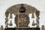San Pedro, façade, gable reliefs with Franciscan insignia