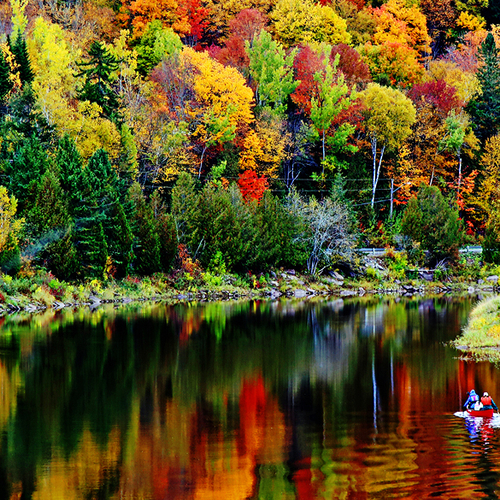 Canoeists paddle along the Hammond River in rural Kings County, New Brunswick Canada.