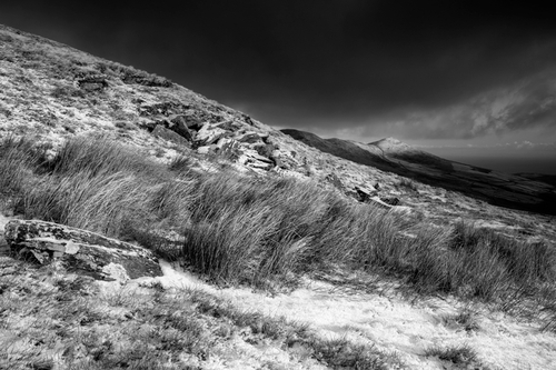 The distant snow covered peak of North Barrule catching the early morning sun as shot from Clagh Ouyr.