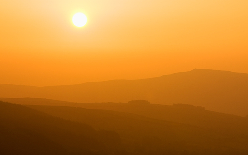 The distant hill of Slieau Whallian through the haze.
