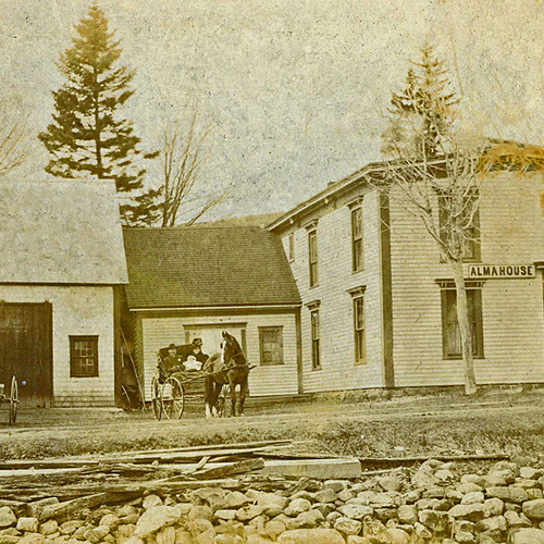 A young family in a horse drawn wagon is seen parked outside of Alma House in Alma, Albert County, New Brunswick Cana…