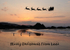 LO98 Santa passes over Looe Beach at sunrise