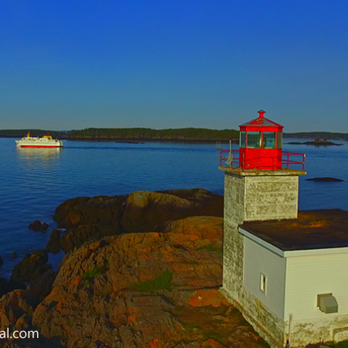 Aerial Drone POV of Pea Point Lighthouse in Blacks Harbor New Brunswick Canada & with the Grand Manan ferry passing b…