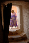 Matmata troglodyte house storeroom woman by door