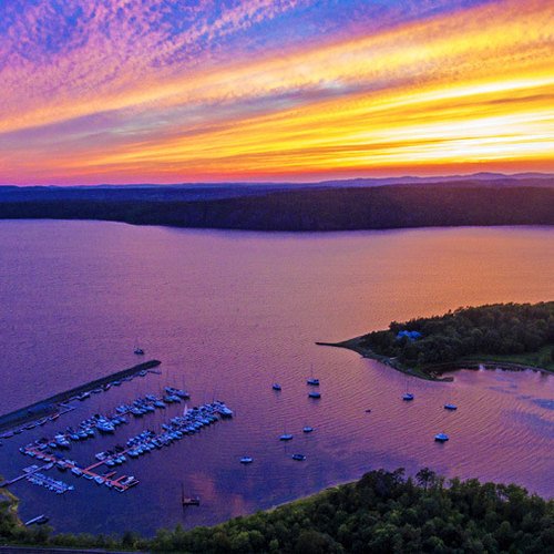 Brilliant striated sunset over Kennebecasis Bay at Rothesay, New Brunswick, Canada via aerial drone.