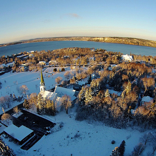 An aerial capture of Rothesay Common, the Post Office, St Paul's, Our Lady of Perpetual Help, Kennebecasis Bay, & Lon…