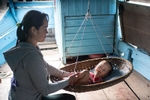 Boat lady and baby, the Perfume River, Hue