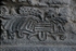 Façade, lower story, pillar base relief