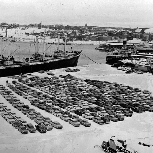 Circa 1960. A large shipment of freshly unloaded vehicles(mostly Vauxhalls) @ the Port of Saint John lay waiting for…