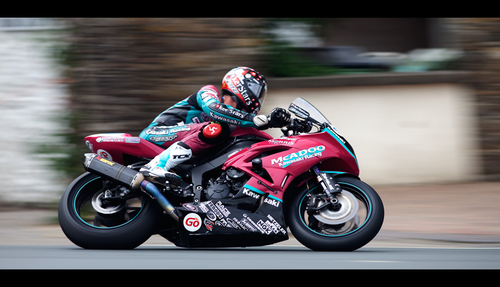 Conor Cummins, the two metre man, panned on his way through Union Mills during the Supersport TT race 1.