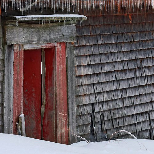 Icicles form along the side of an old country barn.