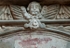 San Juan Bautista, lateral portal architrave detail, cherub