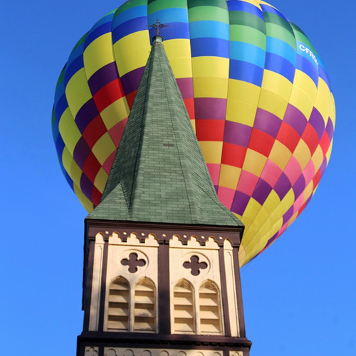 A hot air balloon ride gets nose to nose with the steeple and belfry of Trinity Anglican Church in Sussex, New Brunsw…