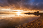 Sunset Under Storm Clouds