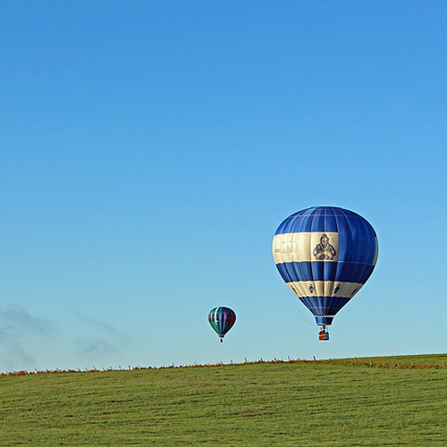 Three hot-air balloons rise above the horizon of a farmer's field in Sussex, New Brunswick. The Balloons were taking…