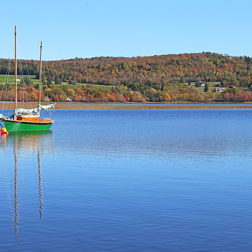 A moored sailboat adds an extra hue to an already colorful riverscape.