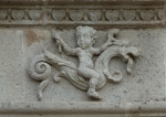 Façade architrave relief, putto aloft hippocamp