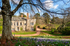 Spring view of Cockington Court with crocuses and daffodils