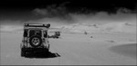Namibia Walvis Bay desert Living Desert dunes and vehicles bw