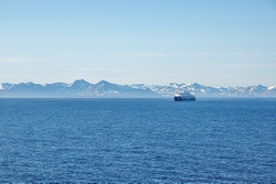Ship against the mountains