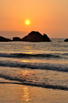 Sunrise over the rocks at Looe Beach portrait