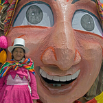 Smiling lady and mask, Cusco, Peru
