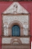 Façade, main portal entablature, choir loft window & pediment