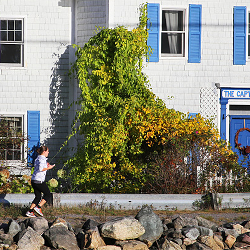 A jogger runs past a colorful B&B at St. Martins New Brunswick