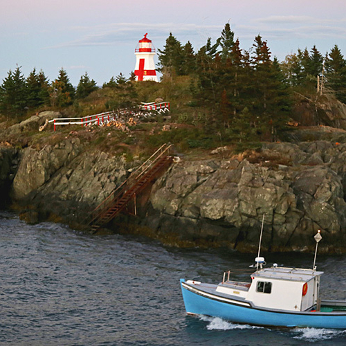 A fishing passes by Head Harbour Lighthouse @ Campobello Island enroute for a day's adventure.