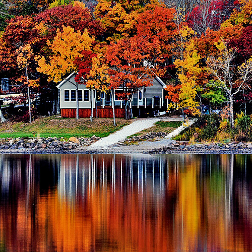 Cottage reflecting upon beautiful Belleisle Bay in rural Kings County, New Brunsick, Canada
