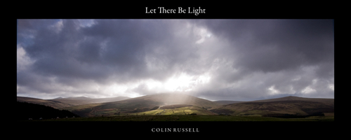 Sunlight poking through the clouds and lighting up the top of Tholt y Will.