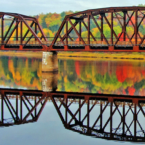 The abandoned Eastern Railway Bridge across the Southwest Miramichi River in autumn.