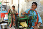 India Porbandar boys with sugar cane squeezer