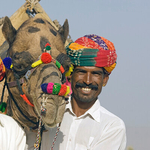 Smiling men and camel Pushkar camel fair  Rajasthan India