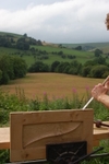 Cutting out the hinges by hand on the handmade door on a sunny day