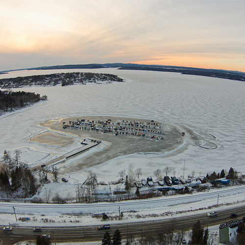 An aerial view of the frozen Kennebecasis including Rothesay Road, CNR railway, Renforth Boat Club, & the 100+ ice sh…