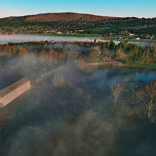 The Bloomfield Creek Covered Bridge surrounded by water and enveloped in Mist amid the Great Spring Flood of 2018.