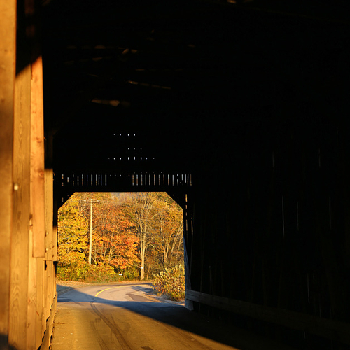 Warm morning sunlight illuminates the covered bridge interior at Bloomfield, New Brunswick.