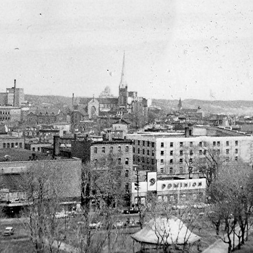 Vintage bird's eye view from atop the Admiral Beatty Hotel showing a portion of King's Square, shops de jour, and bui…