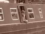 Man at barge window (sepia)