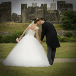 Bride and groom kissing at Caerphilly Castle