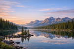 A scenic landscape of the Canadian wilderness with a lake and mountains.