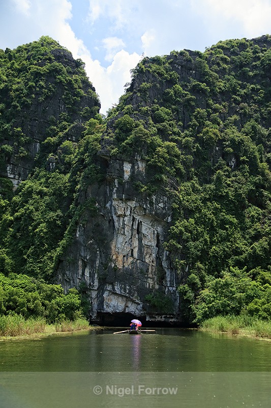 Boat entering Tam Coc cave, Ninh Binh, Vietnam - Vietnam
