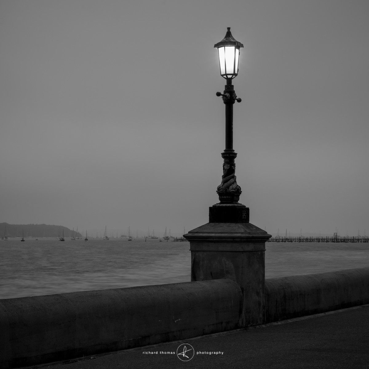 Night photograph of a street lamp besides Poole harbour in Dorset