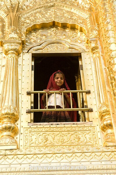 Girl in red saree looking from the Golden Temple, Amritsar, India - Children