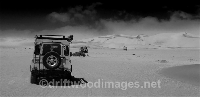 Namibia Walvis Bay desert Living Desert dunes and vehicles bw - Namibia, Southern Africa